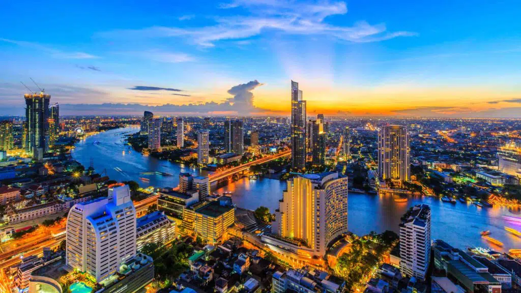 Bangkok city downtown business and finance with Chao Phraya River during sunset sky